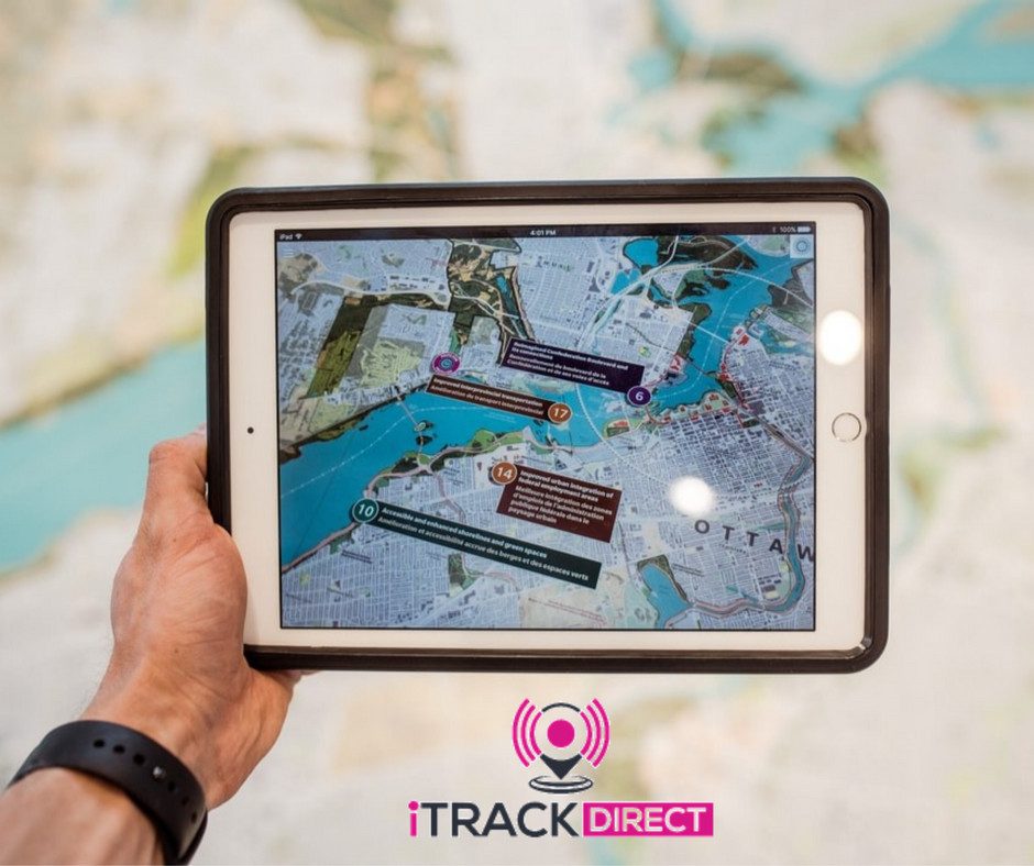 A person using a vehicle tracking system on an iPad.