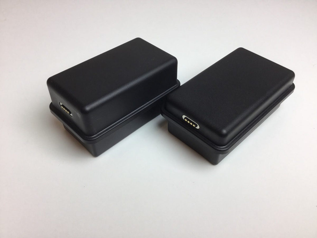 Two black boxes on a white surface.
