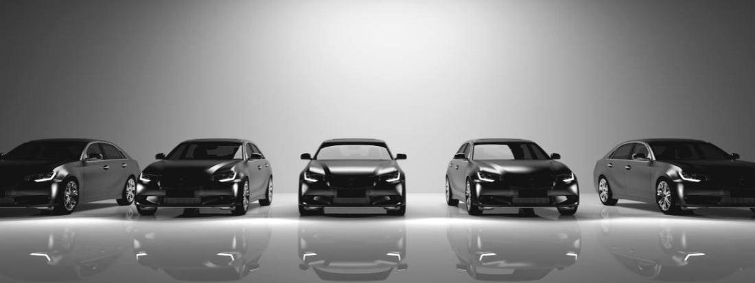 Five black cars in a row on a grey background.